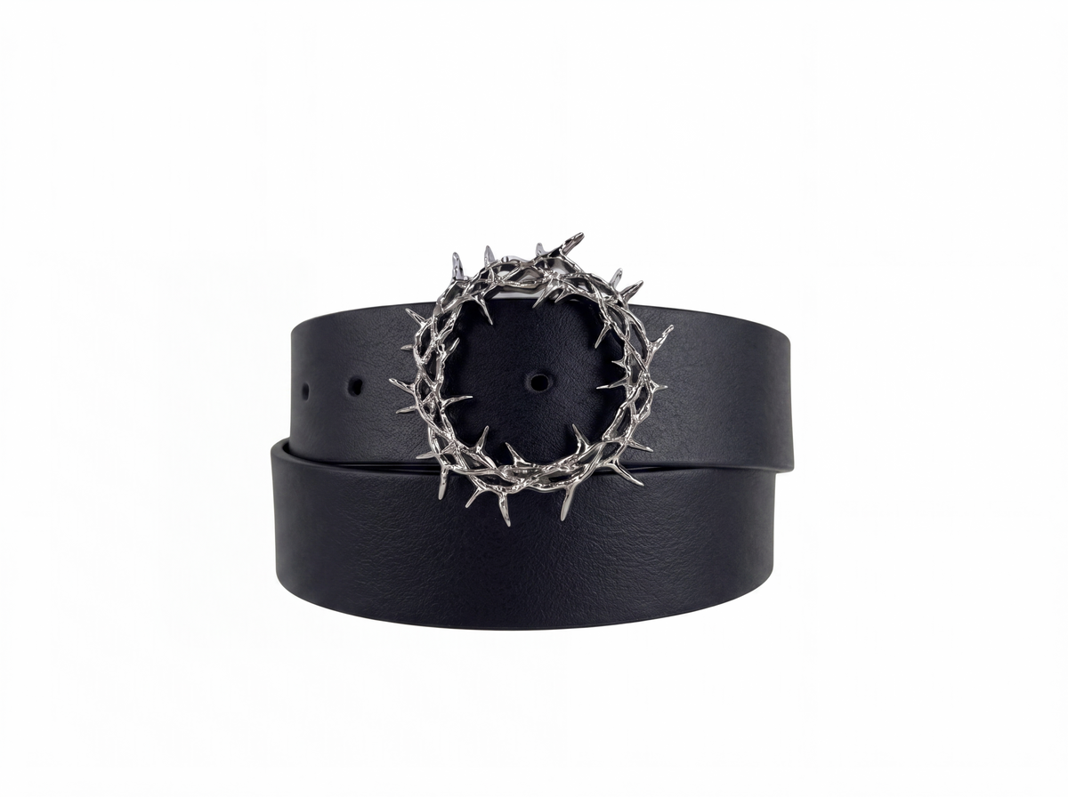 The Kranz — the smooth black leather belt coiled into a loop on white, spiked thorn-crown buckle at the top
