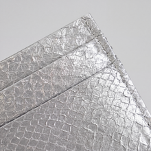 Cardholder salmon leather white — close crop of the upper corner, metallic salmon scale grain and stitched edge